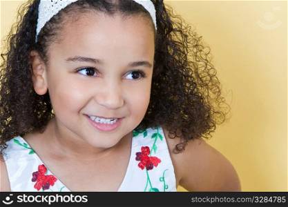 Studio shot of a beautiful young mixed race girl smiling and looking happy