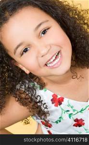Studio shot of a beautiful young mixed race girl smiling and showing off her perfect white teeth