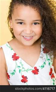 Studio shot of a beautiful young mixed race girl smiling looking cute
