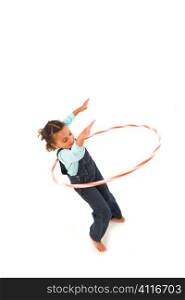 Studio shot of a beautiful young mixed race girl using a hula hoop