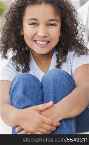 Studio shot of a beautiful young mixed race interracial African American girl child smiling and showing off her perfect white teeth