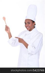 Studio shot of a female chef with a wooden spoon