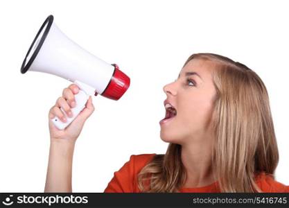 Studio shot of a girl shouting into a megaphone