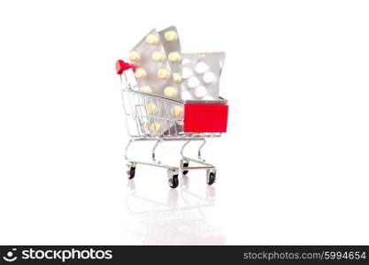 Studio shot of a small shopping cart full of pills