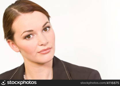 Studio shot of a smartly dressed beautiful young brunette woman with striking brown eyes looking thoughtful