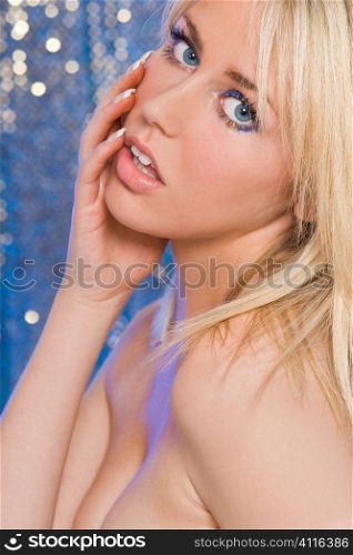 Studio shot of a stunningly beautiful young blonde woman shot with an electric blue background