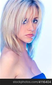 Studio shot of a stunningly beautiful young blonde woman shot with blue backlighting