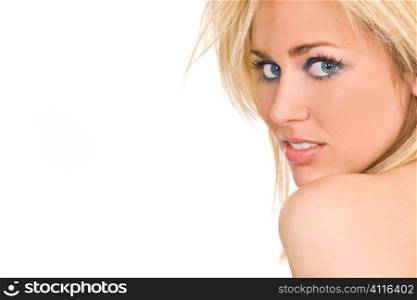 Studio shot of a stunningly beautiful young blonde woman with striking blue eyes looking back over her shoulder. Shot with copy space.