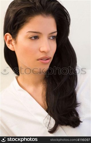 Studio shot of a stunningly beautiful young Latina woman dressed all in white