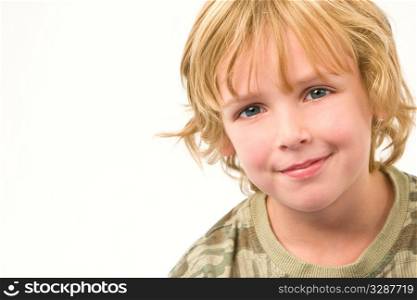 Studio shot of a young blonde boy with a happy smile