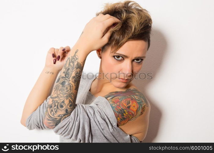 Studio shot of a young tattooed woman