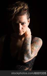 Studio shot of a young tattooed woman