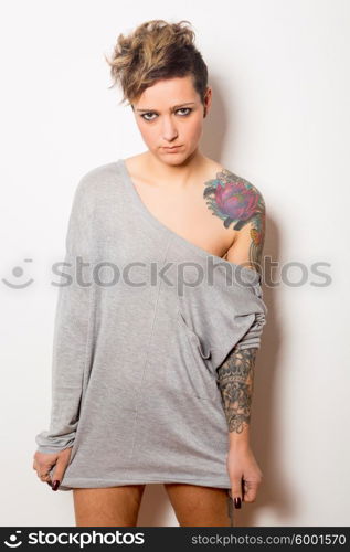 Studio shot of a young tattooed woman