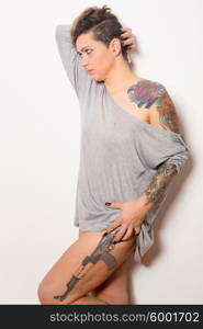 Studio shot of a young tattooed woman