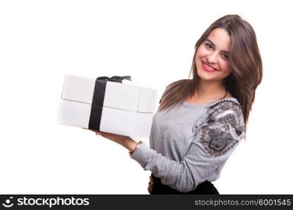 Studio shot of a young woman holding a present, isolated over white