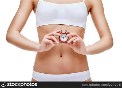 studio shot of attractive young woman with beautiful body holding small red alar clock isolated on white.. studio shot of attractive young woman with beautiful body holding small red alar clock isolated on white