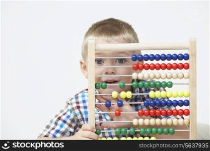 Studio Shot Of Boy Playing With Abacus