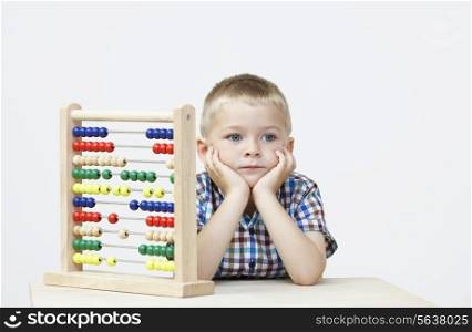 Studio Shot Of Boy Playing With Abacus