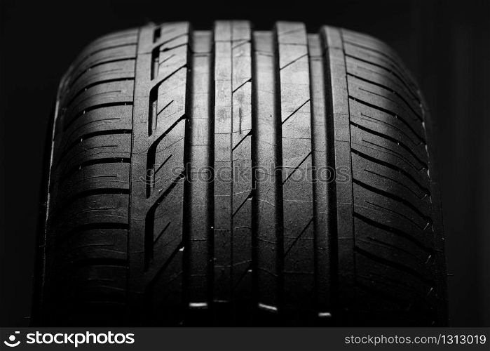 Studio shot of brand new car tire isolated on black background. close up.. Studio shot of brand new car tire isolated on black background. close up