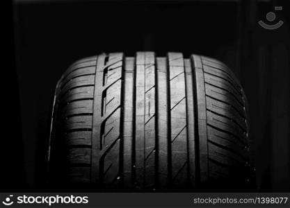 Studio shot of brand new car tire isolated on black background. close up. Studio shot of brand new car tire isolated on black background. close up.