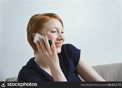 Studio shot of businessman talking on mobile phone