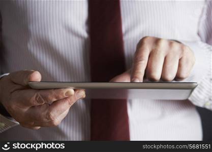 Studio Shot Of Businessman Using Digital Tablet