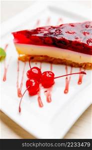 studio shot of cherry cheesecake slice on plate. cherry cheesecake close-up on white palte