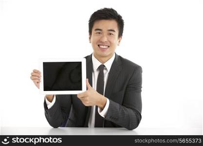Studio Shot Of Chinese Businessman Working On Tablet Computer