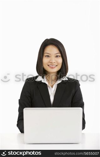 Studio Shot Of Chinese Businesswoman Working On Laptop