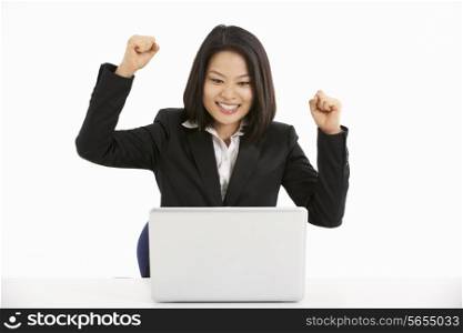 Studio Shot Of Chinese Businesswoman Working On Laptop And Celebrating
