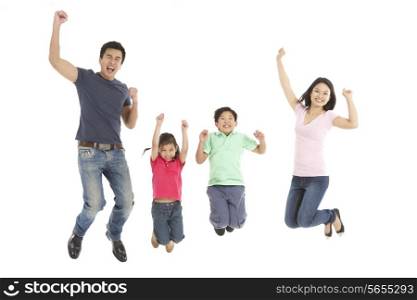 Studio Shot Of Chinese Family Jumping In Air