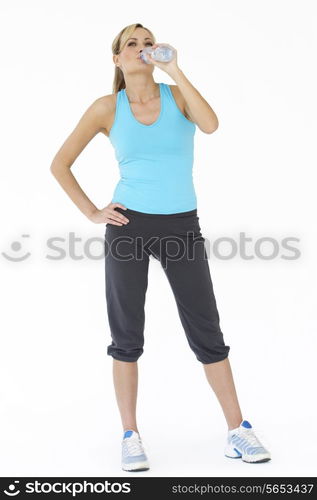 Studio Shot Of Exercising Woman Drinking Water