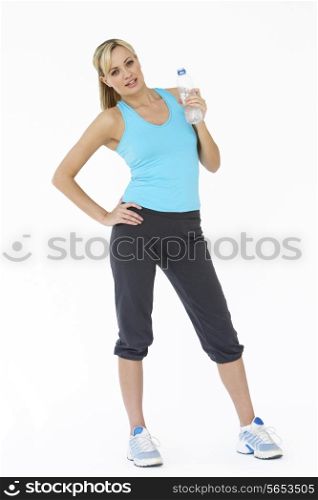 Studio Shot Of Exercising Woman Drinking Water