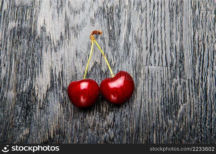 Studio shot of fresh natural cherries on wooden background. Studio shot of Fresh cherries