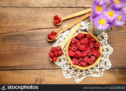Studio shot of fresh natural raspberries on wooden background. Studio shot of Fresh raspberries