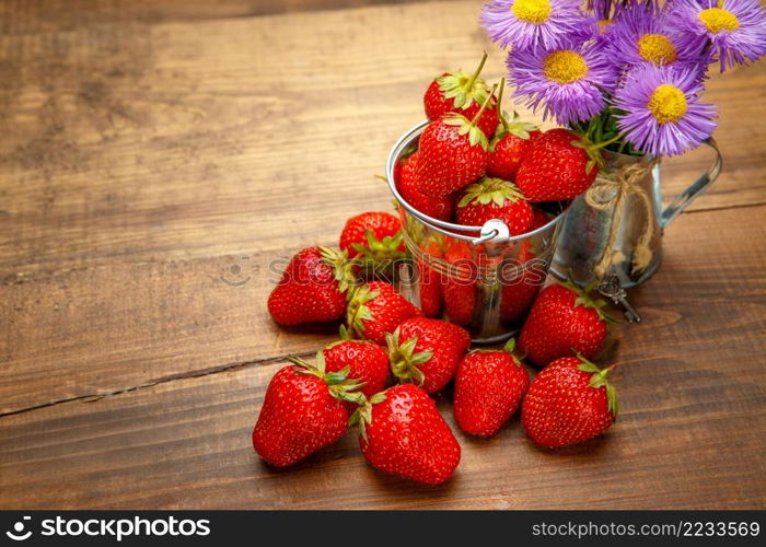 Studio shot of fresh natural strawberries on wooden background. Fresh strawberries