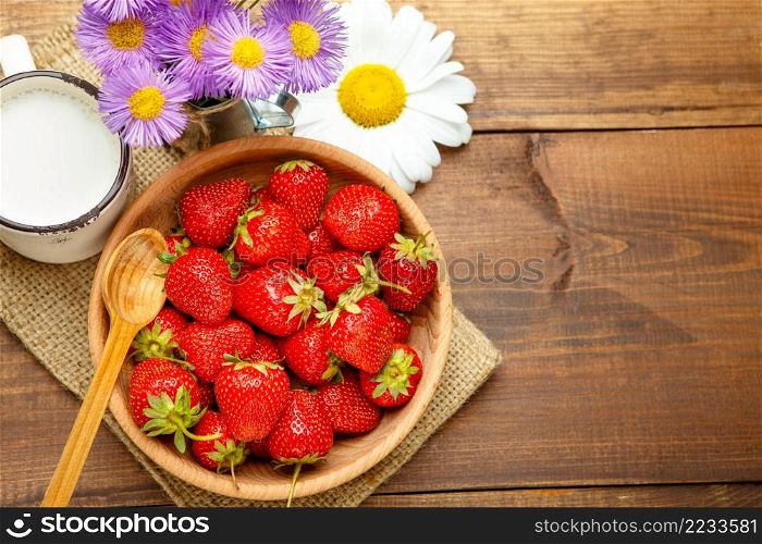 Studio shot of fresh natural strawberries on wooden background. Fresh strawberries