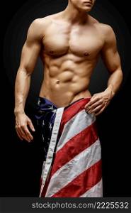 Studio shot of Handsome young man’s torso. Handsome young man’s torso covered with american flag