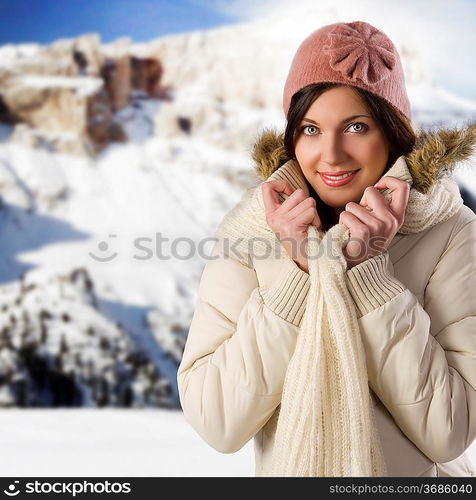 studio shot of nice girl with pink cap and scarf and white winter jacket