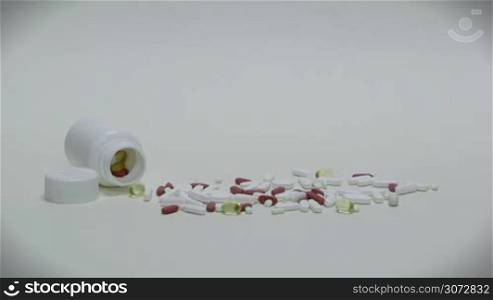 Studio shot of pills, prescription drugs, medications, medicines, diet supplement. Sick man, ill people, sickness, disease, illness, health care concept. Substance abuse, doping. Slow motion