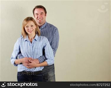 Studio Shot Of Relaxed Middle Aged Couple