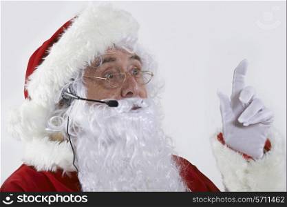 Studio Shot Of Santa Claus Wearing Headset
