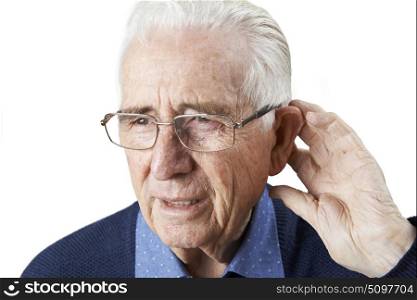 Studio Shot Of Senior Man Suffering From Deafness