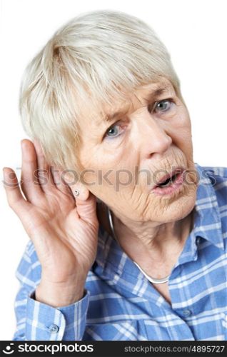 Studio Shot Of Senior Woman Suffering From Deafness