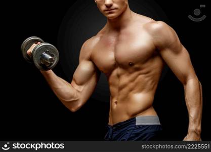 Studio shot of Shirtless bodybuilder holding dumbell and showing his muscular arms.. Shirtless bodybuilder holding dumbell and showing his muscular arms.