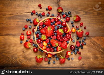 Studio shot of summer berries on wooden background. Fresh summer berries