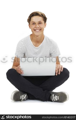 Studio Shot Of Teenage Boy Using Laptop