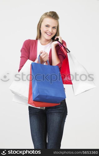 Studio Shot Of Teenage Girl With Shopping Bags