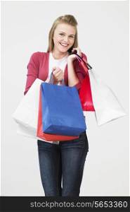 Studio Shot Of Teenage Girl With Shopping Bags
