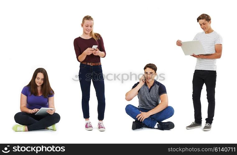 Studio Shot Of Teenagers Using Communication Technology